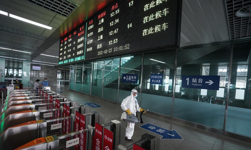 A staff member disinfects at Nanjing Railway Station in Nanjing, capital of east China's Jiangsu Province, Aug. 23, 2021. Nanjing, which witnessed the country's latest resurgence of coronavirus cluster infections attributable to the Delta variant, cleared all medium- and high-risk areas for COVID-19 on Aug. 19. From Aug. 23, people leaving Nanjing by rail, highway, waterway, etc. will no longer be required to provide negative nucleic acid test certificates. (Xinhua/Ji Chunpeng) 