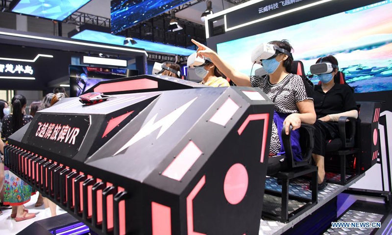 Visitors experience VR devices at the Smart China Expo in Chongqing, southwest China, Aug. 23, 2021. The Smart China Expo 2021 opened in Chongqing on Monday, with more than 600 enterprises participating in the exhibition online and offline. (Photo: Xinhua)