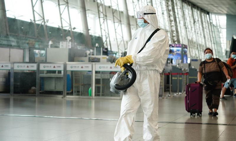 A staff member disinfects at Nanjing Railway Station in Nanjing, capital of east China's Jiangsu Province, Aug. 23, 2021. Nanjing, which witnessed the country's latest resurgence of coronavirus cluster infections attributable to the Delta variant, cleared all medium- and high-risk areas for COVID-19 on Aug. 19. From Aug. 23, people leaving Nanjing by rail, highway, waterway, etc. will no longer be required to provide negative nucleic acid test certificates. (Xinhua/Ji Chunpeng)

