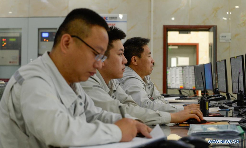 Staff members work at the control room of a photothermal power station in Hami, northwest China's Xinjiang Uygur Autonomous Region, Aug. 22, 2021. The photothermal power station is the first of its kind in Xinjiang. The project is a modern attempt by the region to capitalize on its abundant solar energy and turn it into heat and power. (Xinhua/Gao Han)

