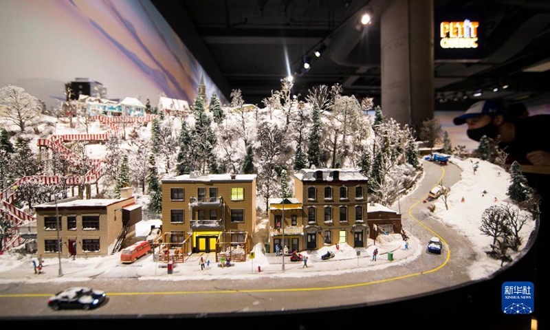 A man views Petit Quebec during Little Canada exhibition in Toronto, Canada, on Aug. 28, 2021. With several geographically-themed areas, the immersive exhibition Little Canada offered visitors a bird's eye view of Canada with the mostly 1:87 scale replica buildings here from this August. (Photo by Zou Zheng/Xinhua)