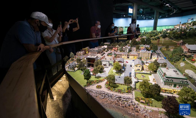 People view Little Niagara Area during Little Canada exhibition in Toronto, Canada, on Aug. 28, 2021. With several geographically-themed areas, the immersive exhibition Little Canada offered visitors a bird's eye view of Canada with the mostly 1:87 scale replica buildings here from this August. (Photo by Zou Zheng/Xinhua)