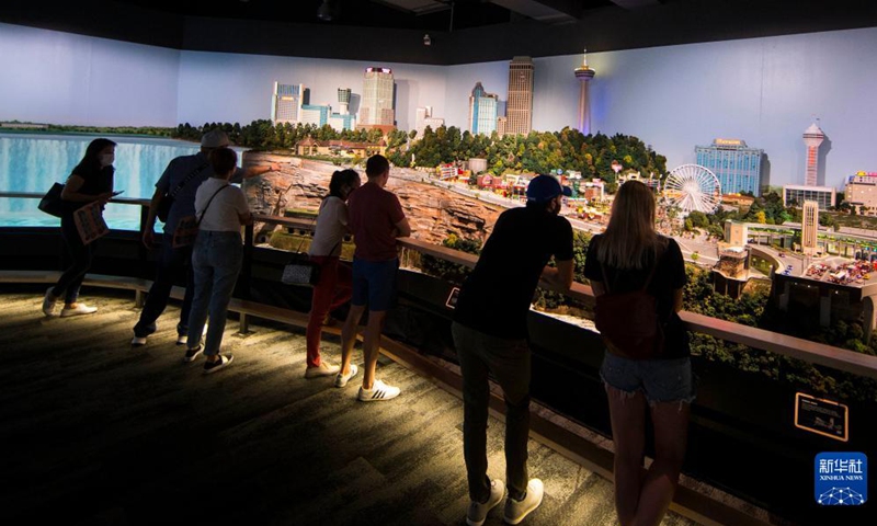 People view Little Niagara Area during Little Canada exhibition in Toronto, Canada, on Aug. 28, 2021. With several geographically-themed areas, the immersive exhibition Little Canada offered visitors a bird's eye view of Canada with the mostly 1:87 scale replica buildings here from this August. (Photo by Zou Zheng/Xinhua)