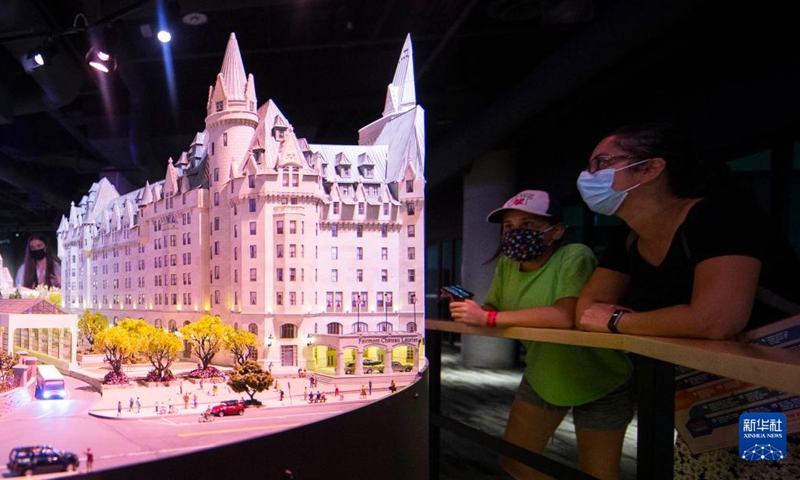 People view Little Ottawa Area during Little Canada exhibition in Toronto, Canada, on Aug. 28, 2021. With several geographically-themed areas, the immersive exhibition Little Canada offered visitors a bird's eye view of Canada with the mostly 1:87 scale replica buildings here from this August. (Photo by Zou Zheng/Xinhua)