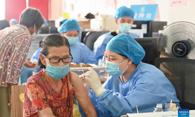 A medical worker inoculates an old woman with a dose of COVID-19 vaccine in Neikeng Town in Jinjiang City, southeast China's Fujian Province, Aug. 31, 2021. Photo: Xinhua 