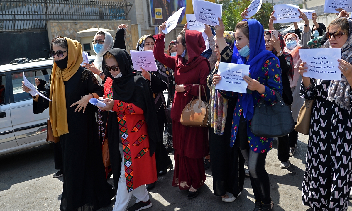 Afghan women take part in a protest march for their rights under Taliban rule in downtown Kabul on Friday. The Taliban has said women will be able to continue their education and work outside the home, rights denied to women when the militants were last in power. But the Taliban has also vowed to impose Sharia, or Islamic law, without providing specifics, according to AP. Photo: AFP