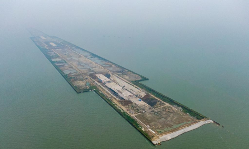 Aerial photo taken on Sept. 5, 2021 shows the construction site of Nanquan section of Taihu tunnel, part of the Changzhou-Wuxi Highway, in Wuxi, east China's Jiangsu Province. The main construction of the Nanquan section of the Taihu tunnel was completed on Sunday. Taihu tunnel, China's longest underwater highway tunnel, is part of the Changzhou-Wuxi Highway which has a total length of 43.9 km. The 10.8-km-long, 43.6-meter-wide tunnel is under Taihu Lake, China's third-largest freshwater lake. (Xinhua/Li Bo) 