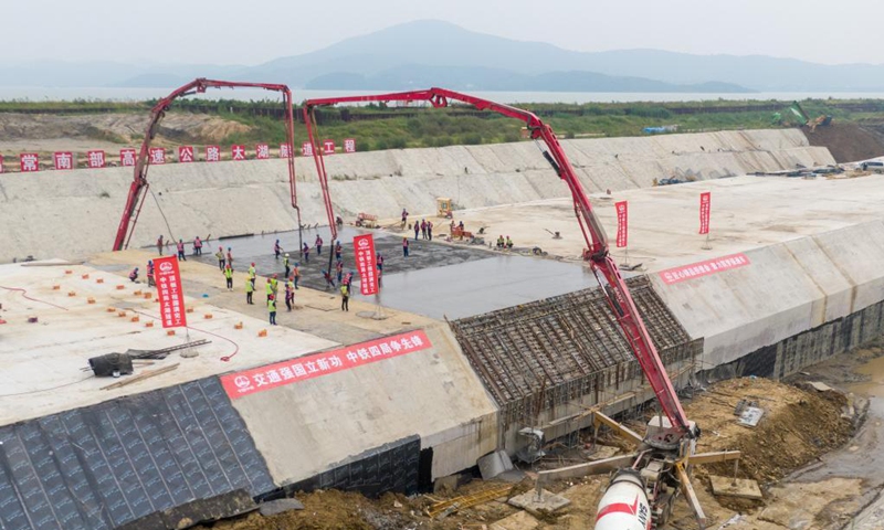 Aerial photo taken on Sept. 5, 2021 shows the construction site of Nanquan section of Taihu tunnel, part of the Changzhou-Wuxi Highway, in Wuxi, east China's Jiangsu Province. The main construction of the Nanquan section of the Taihu tunnel was completed on Sunday. Taihu tunnel, China's longest underwater highway tunnel, is part of the Changzhou-Wuxi Highway which has a total length of 43.9 km. The 10.8-km-long, 43.6-meter-wide tunnel is under Taihu Lake, China's third-largest freshwater lake. (Xinhua/Li Bo) 