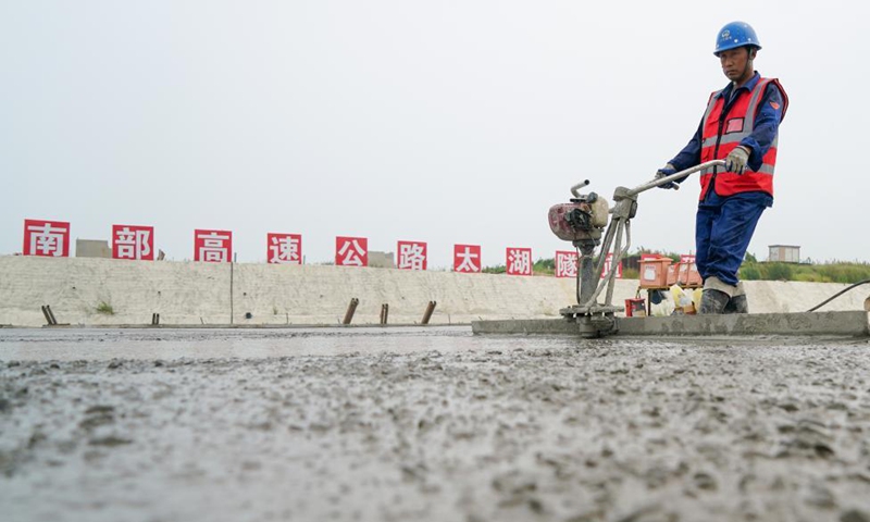 A construction worker is busy at the construction site of Nanquan section of Taihu tunnel, part of the Changzhou-Wuxi Highway, in Wuxi, east China's Jiangsu Province, Sept. 5, 2021. The main construction of the Nanquan section of the Taihu tunnel was completed on Sunday. Taihu tunnel, China's longest underwater highway tunnel, is part of the Changzhou-Wuxi Highway which has a total length of 43.9 km. The 10.8-km-long, 43.6-meter-wide tunnel is under Taihu Lake, China's third-largest freshwater lake. (Xinhua/Li Bo) 