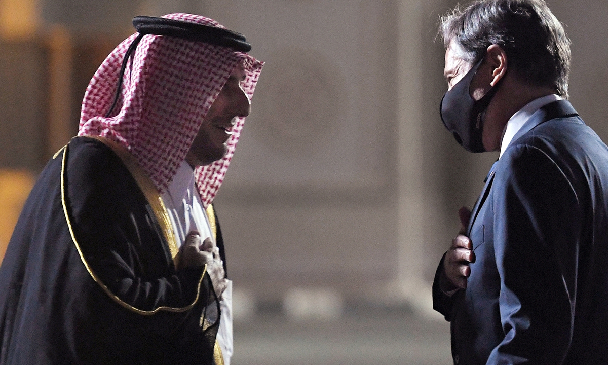 US Secretary of State Antony Blinken (R) is welcomed upon his arrival by MFA Director of Protocol Ambassador Ibrahim Fakhroo (L) at Old Doha Airport in Qatar's capital on Monday. 