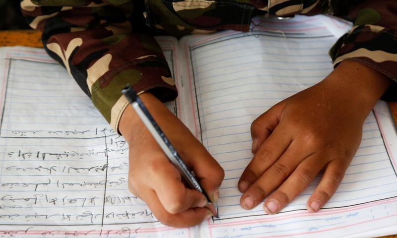 A child takes note during a class at a school in Sanaa, Yemen, on Sept. 8, 2021.The International Literacy Day declared by UNESCO is observed each year on Sept. 8.Photo:Xinhua