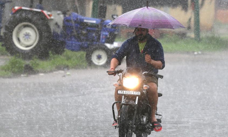 A man rides a motorbike in a heavy rain in Amritsar district of India's northern state Punjab, Sept. 8, 2021.Photo:Xinhua