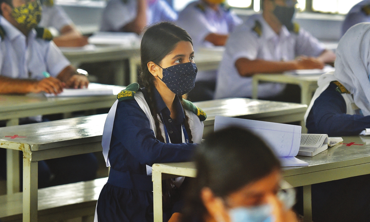 Students attend their class at the Rajuk Uttara Model College in Dhaka, the capital city of Bangladesh on Sunday, as Bangladesh schools reopened after 18 months in one of the world's longest shutdowns due to the COVID-19 pandemic. Photo: AFP