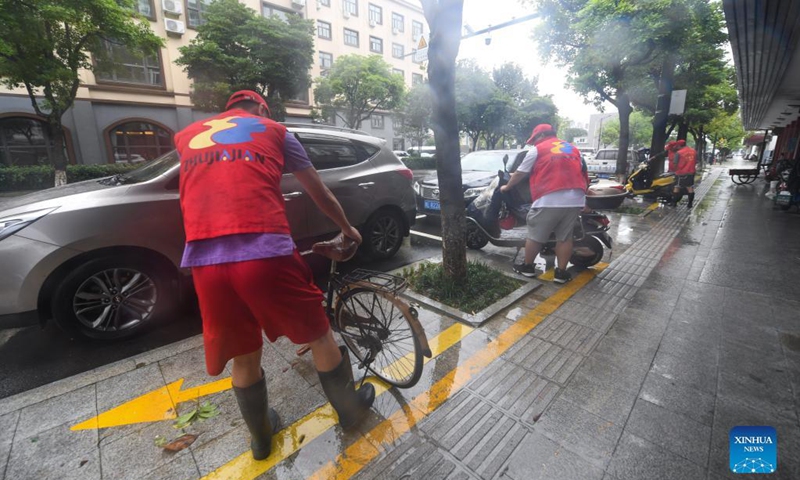 VVolunteers lift up bikes in Zhoushan, east China's Zhejiang Province, Sept. 14, 2021. The disaster relief work is underway in Zhoushan as the influence of Typhoon Chanthu weakens. Photo: Xinhua 