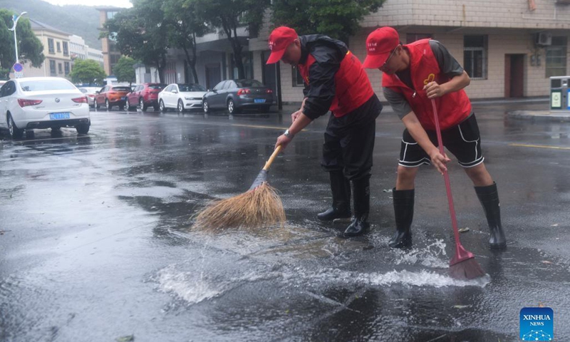 Volunteers clean a road in Zhoushan, east China's Zhejiang Province, Sept. 14, 2021. The disaster relief work is underway in Zhoushan as the influence of Typhoon Chanthu weakens. Photo: Xinhua 