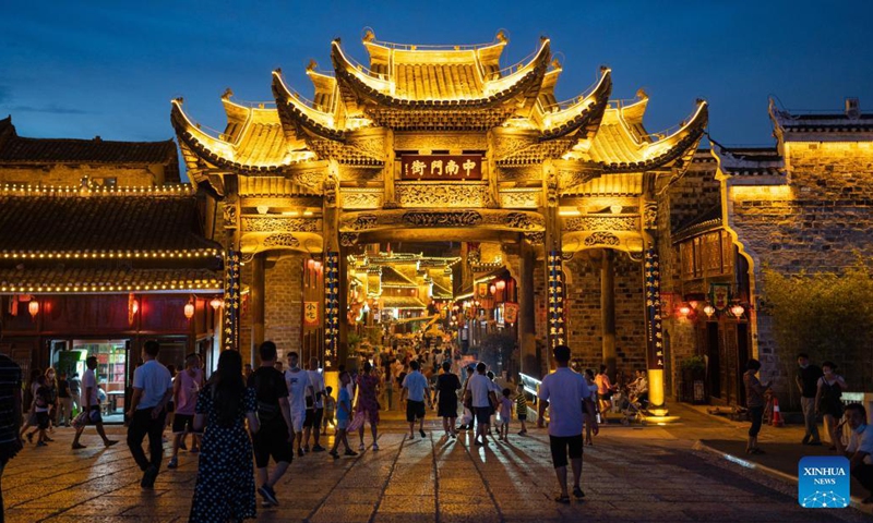 Visitors are seen at Zhongnanmen Historical and Cultural Tourist Area in Tongren City, southwest China's Guizhou Province, on Aug. 20, 2021. (Photo by Peng Jun/Xinhua)