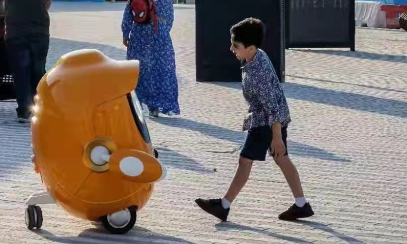 Opti interacting with a kid at Expo 2020 Dubai