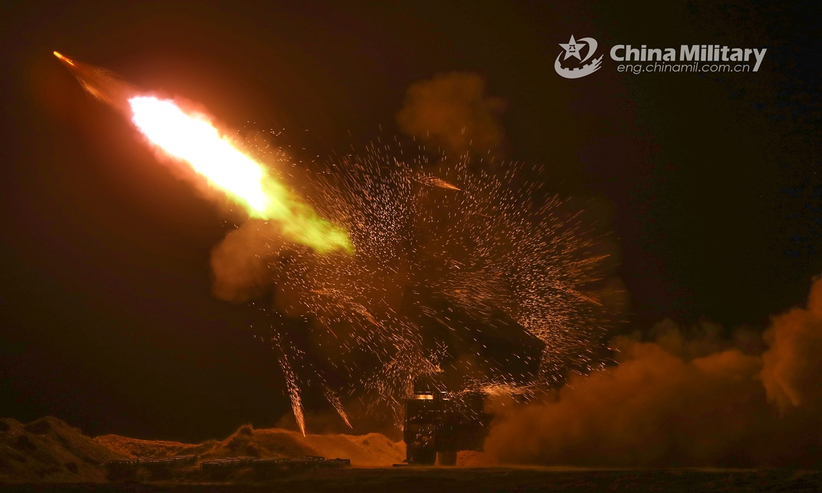 A vehicle-mounted rocket launcher attached to an artillery contingent of a regiment under the PLA Xinjiang Military Command fires at mock targets during a round-the-clock live-fire training exercise on September 30, 2021. (eng.chinamil.com.cn/Photo by Huang Feihao)