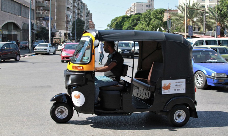 A tuk-tuk driver looks for passengers on a street in Tripoli, Lebanon, on Oct. 8, 2021.(Photo: Xinhua)