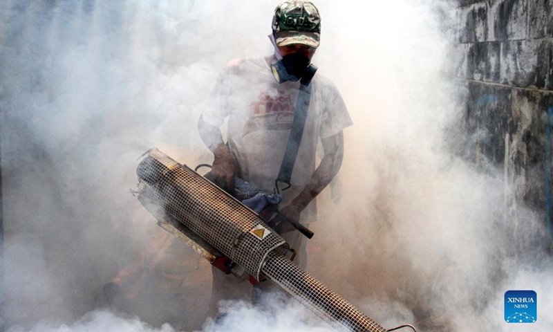 A worker sprays anti-mosquito fog at a residential area in Depok, West Java, Indonesia, Oct. 17, 2021.(Photo: Xinhua)