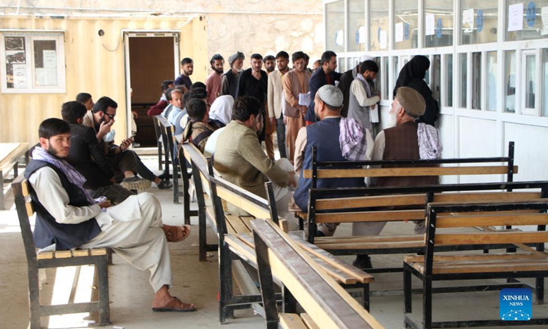 People wait to receive their electronic national identity cards (e-ID cards) in Kabul, capital of Afghanistan, Oct. 17, 2021. Authorities in Kabul have resumed the electronic national identity card issuance service, the local television channel Tolonews reported Sunday. The service was resumed Saturday after two months of a halt and in the first phase, 80,000 e-ID cards will be issued, the report said.(Photo: Xinhua)