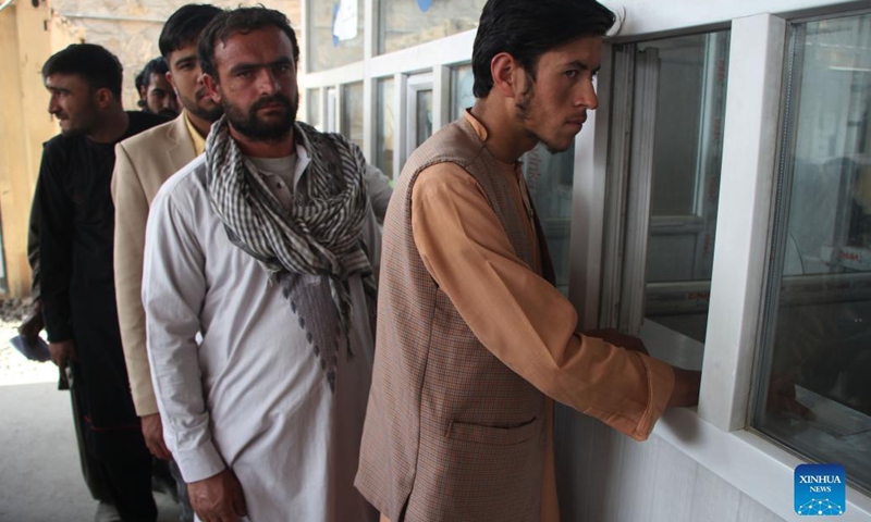 People wait to receive their electronic national identity cards (e-ID cards) in Kabul, capital of Afghanistan, Oct. 17, 2021. Authorities in Kabul have resumed the electronic national identity card issuance service, the local television channel Tolonews reported Sunday. The service was resumed Saturday after two months of a halt and in the first phase, 80,000 e-ID cards will be issued, the report said.(Photo: Xinhua)