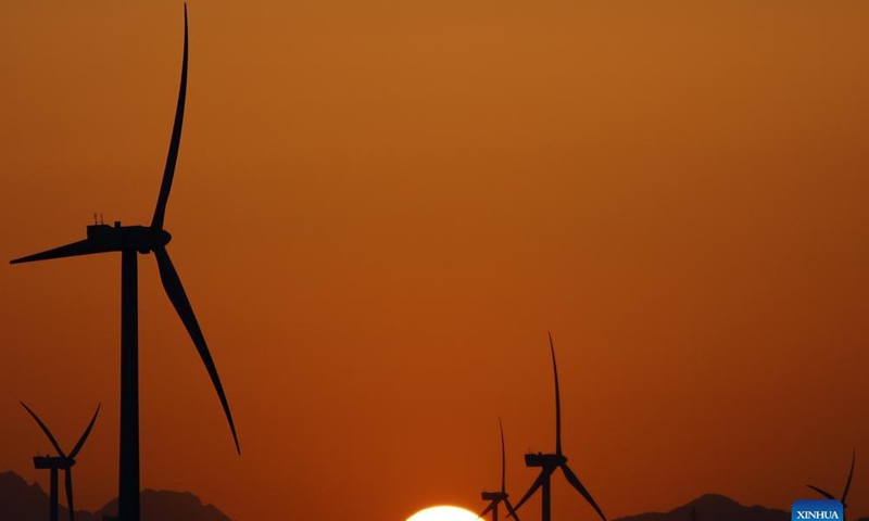 Windmills are silhouetted against the sunset in Hurghada, Egypt, on Oct. 18, 2021.Photo: Xinhua