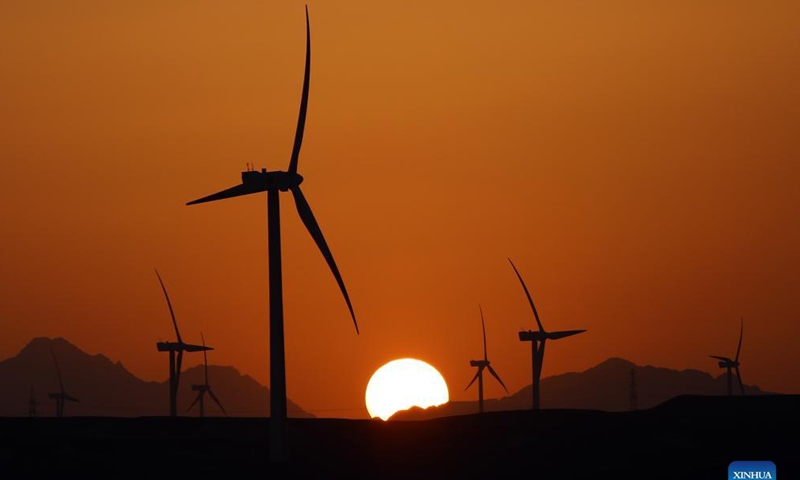 Windmills are silhouetted against the sunset in Hurghada, Egypt, on Oct. 18, 2021.Photo: Xinhua