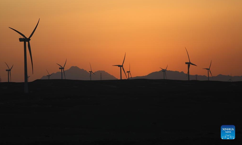 Windmills are silhouetted against the sunset in Hurghada, Egypt, on Oct. 18, 2021.Photo: Xinhua