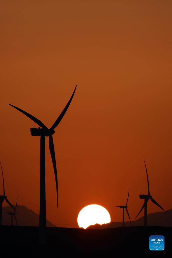 Windmills are silhouetted against the sunset in Hurghada, Egypt, on Oct. 18, 2021.Photo: Xinhua