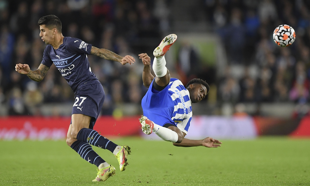 Joao Cancelo (left) of Manchester City fouls Tariq Lamptey of Brighton & Hove Albion at American Express Community Stadium on Saturday in Brighton, England.  Photo: VCG