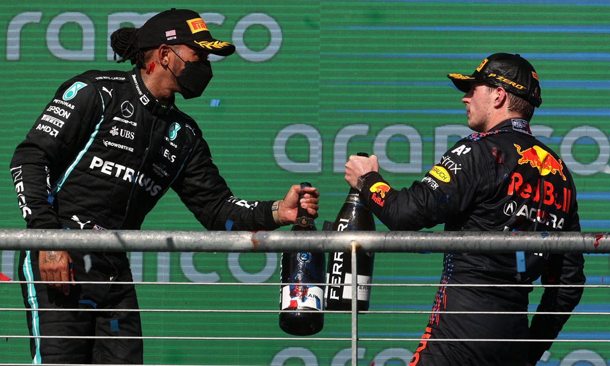 Race winner Max Verstappen (right) and second-placed Lewis Hamilton celebrate on the podium on Sunday in Austin, Texas. Photo: VCG