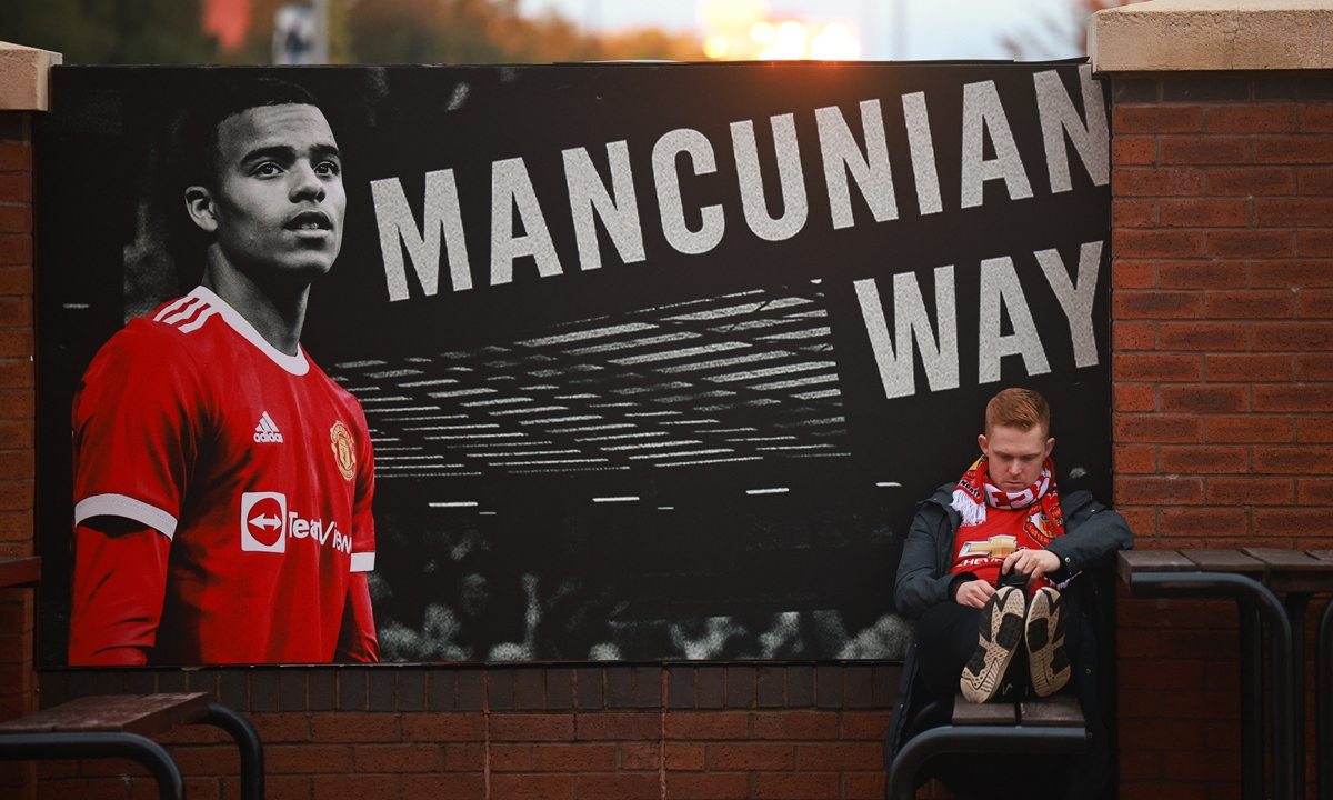 A Manchester United fan is seen looking despondent outside Old Trafford as Liverpool inflict a heavy defeat on the home team on Sunday. Photo: IC