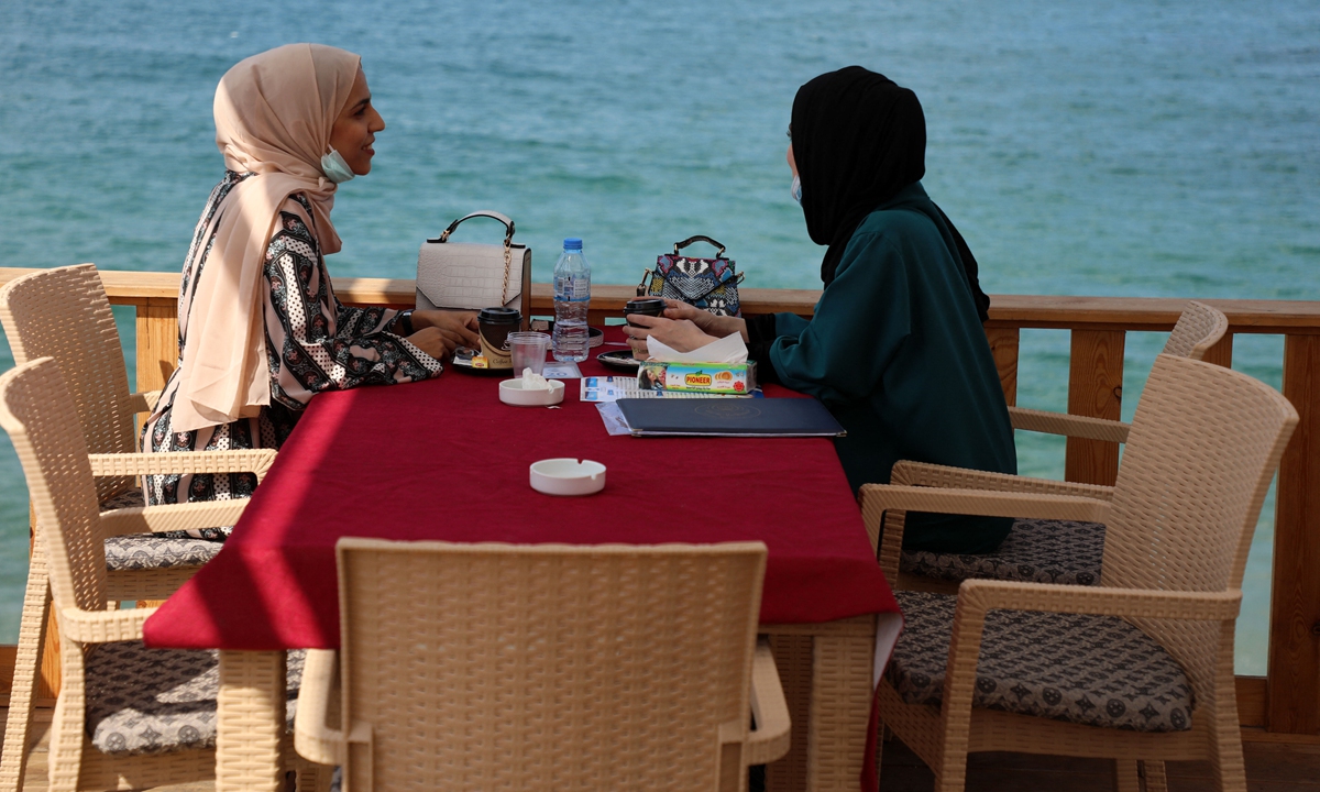 Women enjoy their time at a beach side cafe in Gaza City, on October 12. Photo: AFP