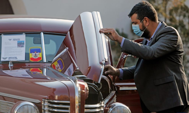 A visitor looks at a 1938 Buick 40 Special vintage car on display during an event organized by Retromobil Club Romania in Bucharest, capital of Romania, on Oct. 28, 2021.Photo:Xinhua