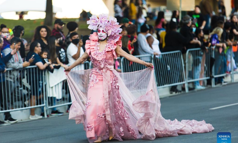 A woman in festival costume is seen during the Dia de los Muertos parade in Dallas, Texas, the United States, Oct. 30, 2021. Dia de los Muertos, known as Day of the Dead, is a well-known traditional Mexican holiday to commemorate deceased loved ones. (Photo:Xinhua)