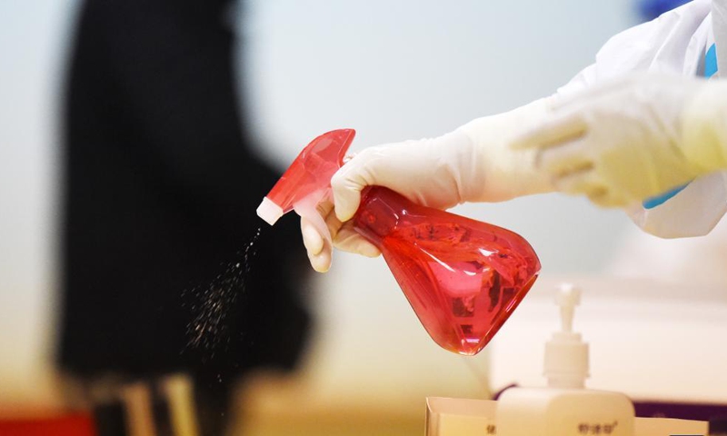 A staff member disinfects facilities at a testing site in Harbin, northeast China's Heilongjiang Province, Oct. 30, 2021.Photo:Xinhua