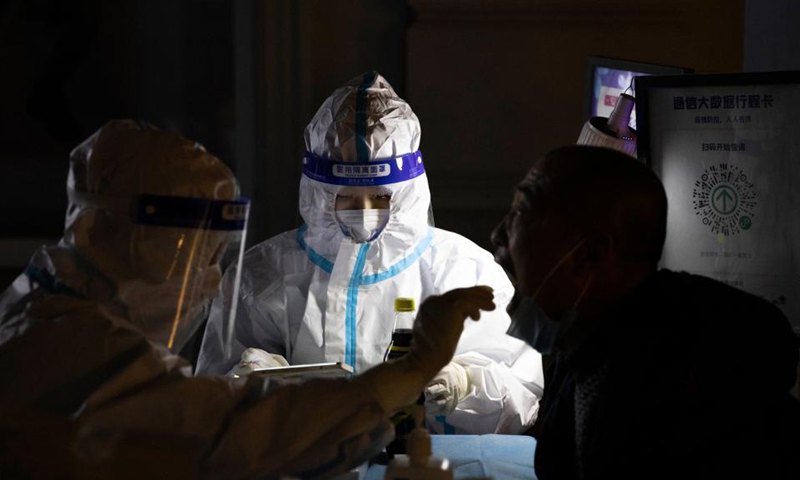 A staff member takes a swab sample from a resident for nucleic acid test at a testing site in Harbin, northeast China's Heilongjiang Province, Oct. 30, 2021.Photo:Xinhua