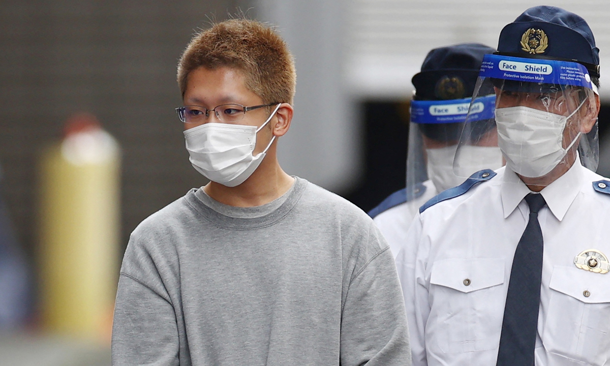 Kyota Hattori (left), suspect in a Halloween stabbing and fire attack on a train that left 18 people hospitalized, is escorted to the prosecutor's office from the Chofu police station in Tokyo, Japan on Tuesday. Top government spokesperson Hirokazu Matsuno described the incident as 