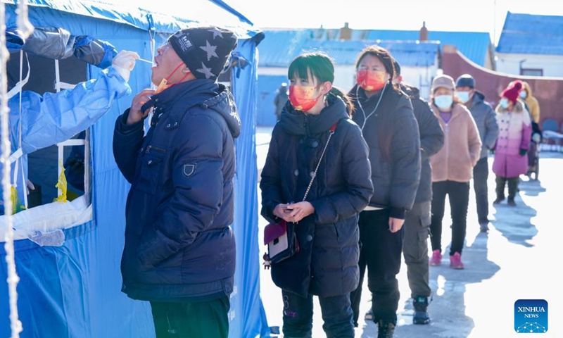 A medical worker takes a swab sample from a resident for nucleic acid testing in Henantun Village of Xingfu Town in Heihe, northeast China's Heilongjiang Province, Nov. 7, 2021.Photo:Xinhua