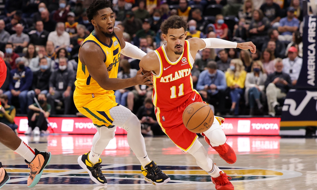 Atlanta Hawks guard Trae Young (right) tries to dribble away from Utah Jazz guard Donovan Mitchell on Tuesday in Salt Lake City. Photo: IC