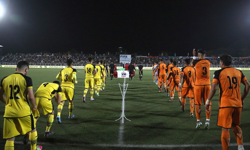 Shaheen Asmaee's players (L) and Simorgh Alborz's players enter the stadium before their Afghan Premier League (APL) football match at Afghanistan Football Federation (AFF) stadium in Kabul, capital of Afghanistan, Oct. 16, 2020.(Photo: Xinhua)