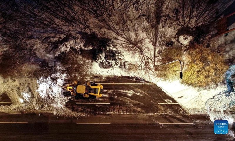 Aerial photo shows a vehicle shoveling snow from the road in Tongliao, north China's Inner Mongolia Autonomous Region, Nov. 11, 2021. In response to the record blizzard, Tongliao government has carried out snow removing operations round-the-clock to resume local transportation.Photo:Xinhua