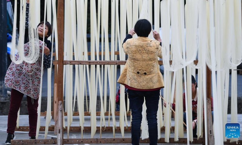 Villagers dry handmade noodles in Huyuan Township of Fuyang District, Hangzhou City, east China's Zhejiang Province, Nov. 16, 2021. Noodle culture festival, noodle making activity, intangible cultural heritage performance and other events have been held in Huyuan Township in recent years, as efforts to promote the development of agricultural and rural tourism industries. Photo: Xinhua