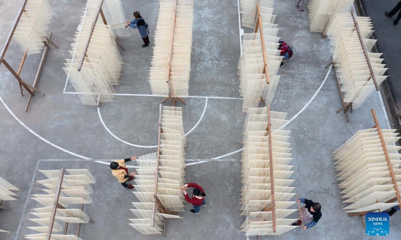 Aerial photo shows villagers drying handmade noodles in Huyuan Township of Fuyang District, Hangzhou City, east China's Zhejiang Province, Nov. 16, 2021. Noodle culture festival, noodle making activity, intangible cultural heritage performance and other events have been held in Huyuan Township in recent years, as efforts to promote the development of agricultural and rural tourism industries. Photo: Xinhua