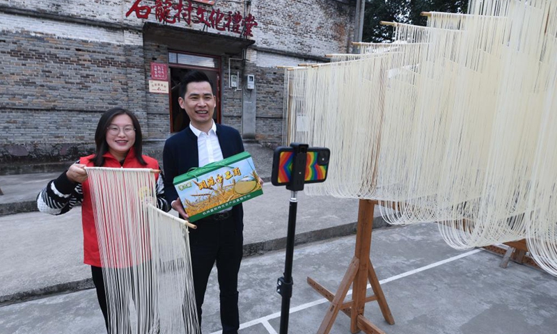 Li Rong (R) and Guo Hongmei sell handmade noodles via live streaming in Huyuan Township of Fuyang District, Hangzhou City, east China's Zhejiang Province, Nov. 16, 2021. Noodle culture festival, noodle making activity, intangible cultural heritage performance and other events have been held in Huyuan Township in recent years, as efforts to promote the development of agricultural and rural tourism industries. Photo: Xinhua