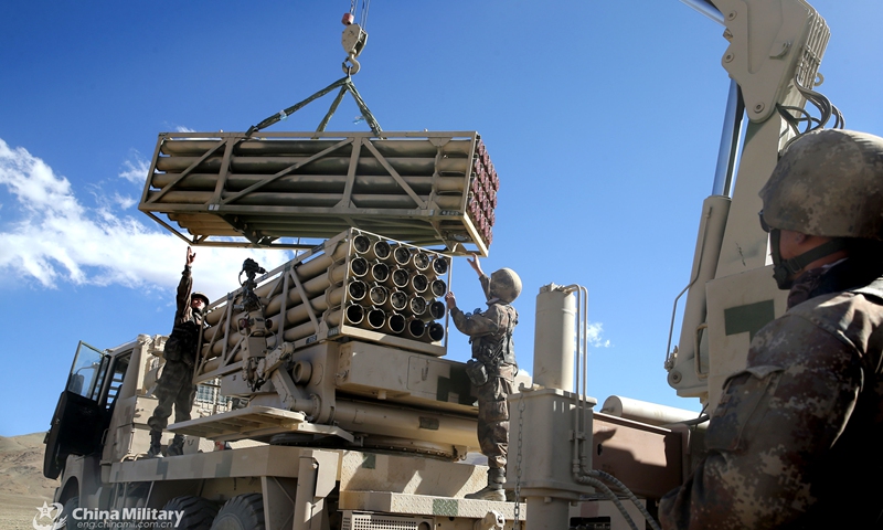 Soldiers assigned to a division under the PLA Xinjiang Military Command use a crane to lift and load rockets onto a military launching truck during a live-fire test in late October, 2021. The training exercise was conducted on the Karakoram Plateau at about 4,500 meters above sea level, with an annual average temperature below -10°C. (eng.chinamil.com.cn/Photo by/ Liu Yong, Li Kang, Zhang Li, Shuai Lijian and Yan Shiqiang)