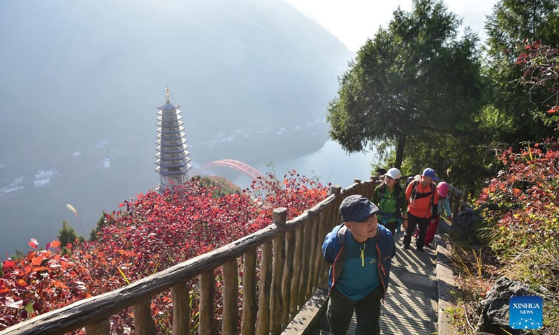 Tourists visit the Wenfeng Scenic Area along the Wuxia Gorge, one of the Three Gorges on the Yangtze River, in Wushan County, southwest China's Chongqing Municipality, Nov. 25, 2021.Photo:Xinhua