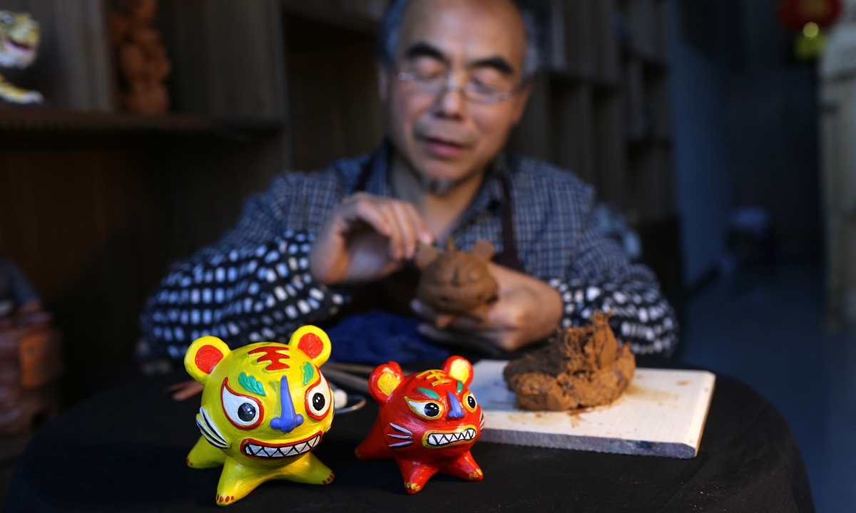 A craftsman makes a tiger sculpture out of clay in Pingding county, North China's Shanxi Province, as the Year of the Tiger draws near. The craft is a traditional Chinese folk art that was included in the first batch of China's intangible cultural heritage list in 2006. Photo: IC