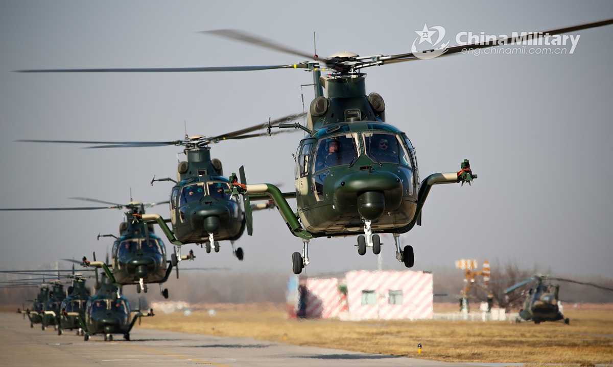 A cluster of Z-9 transport helicopters attached to an army aviation brigade under the PLA 81st Group Army execute hover checks before leaving for a flight training task on November 25, 2021. (eng.chinamil.com.cn/Photo by Chen Kai)